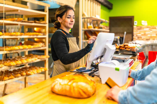 Saleswoman preparing checkout in bakery